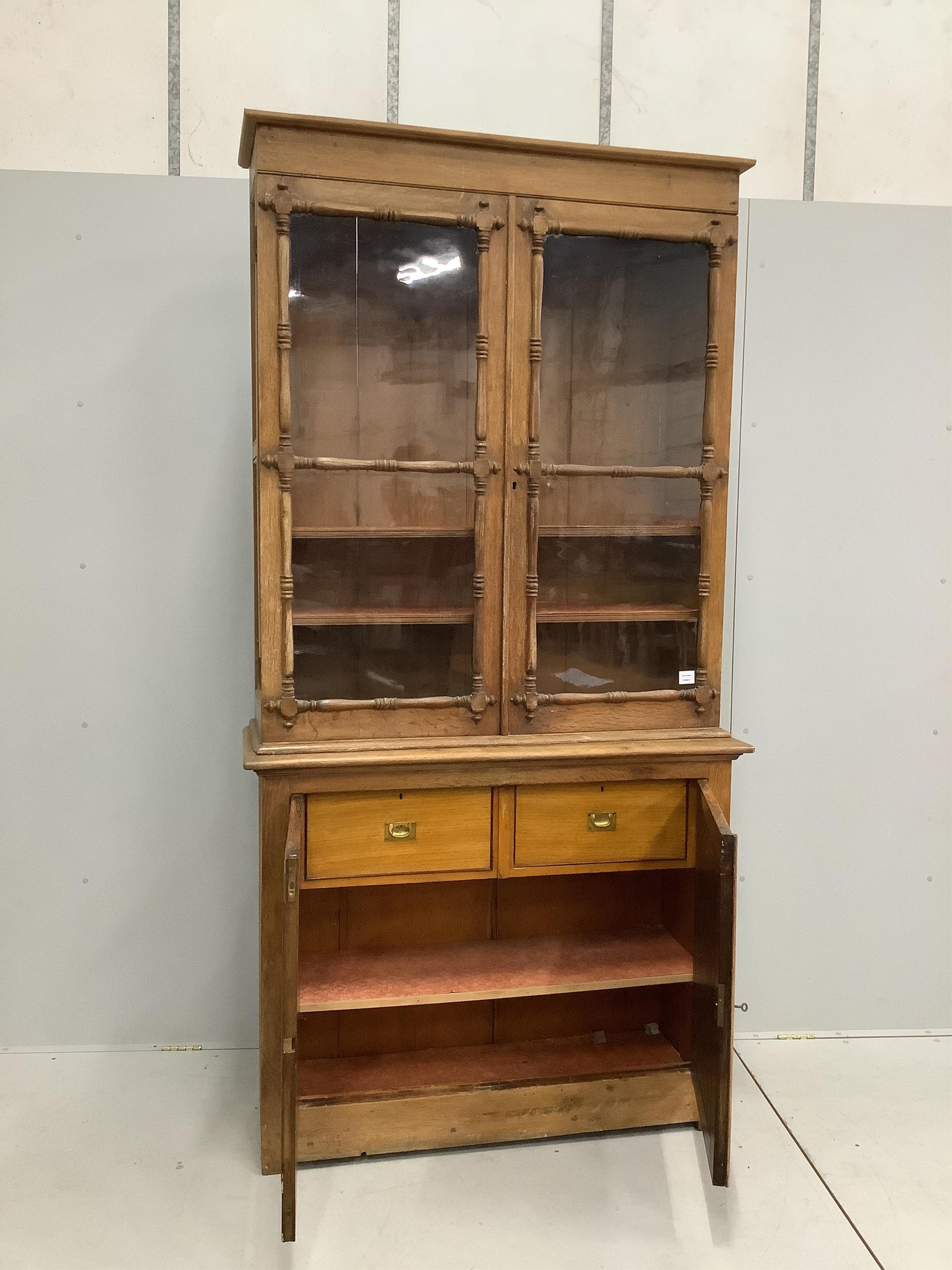 An early Victorian oak bookcase, width 120cm, height 232cm. Condition - some alterations and adaptions, fair